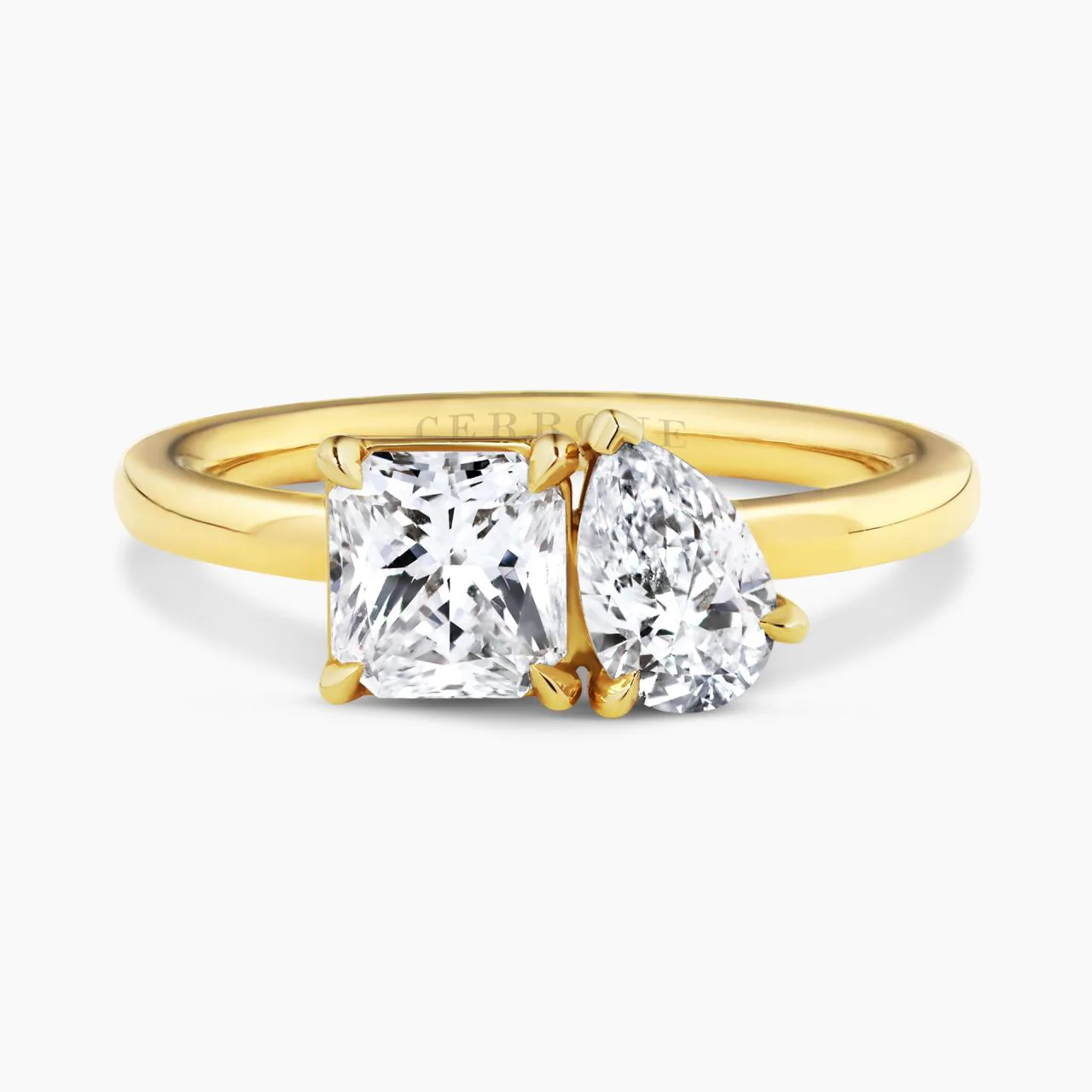 18ct yellow gold 0.88ct square radiant cut and 0.50ct pear shaped diamond engagement ring