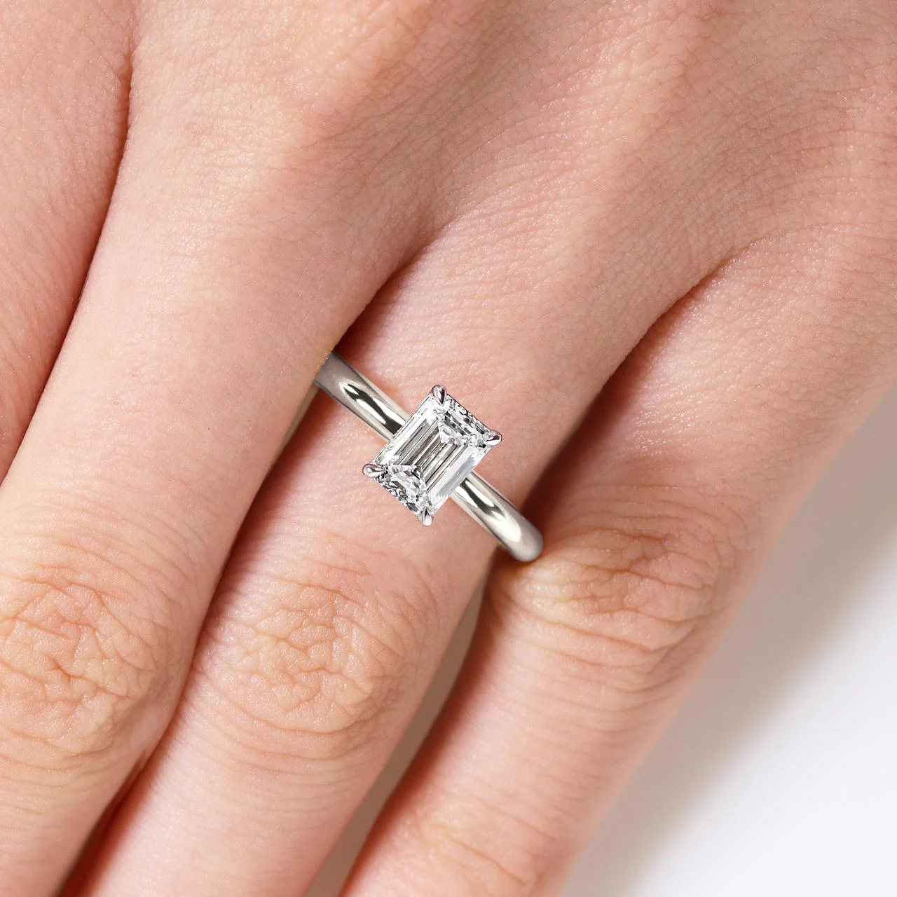 TIVOLI 18ct white gold 1.24ct emerald cut diamond solitaire engagement ring in a four claw setting
